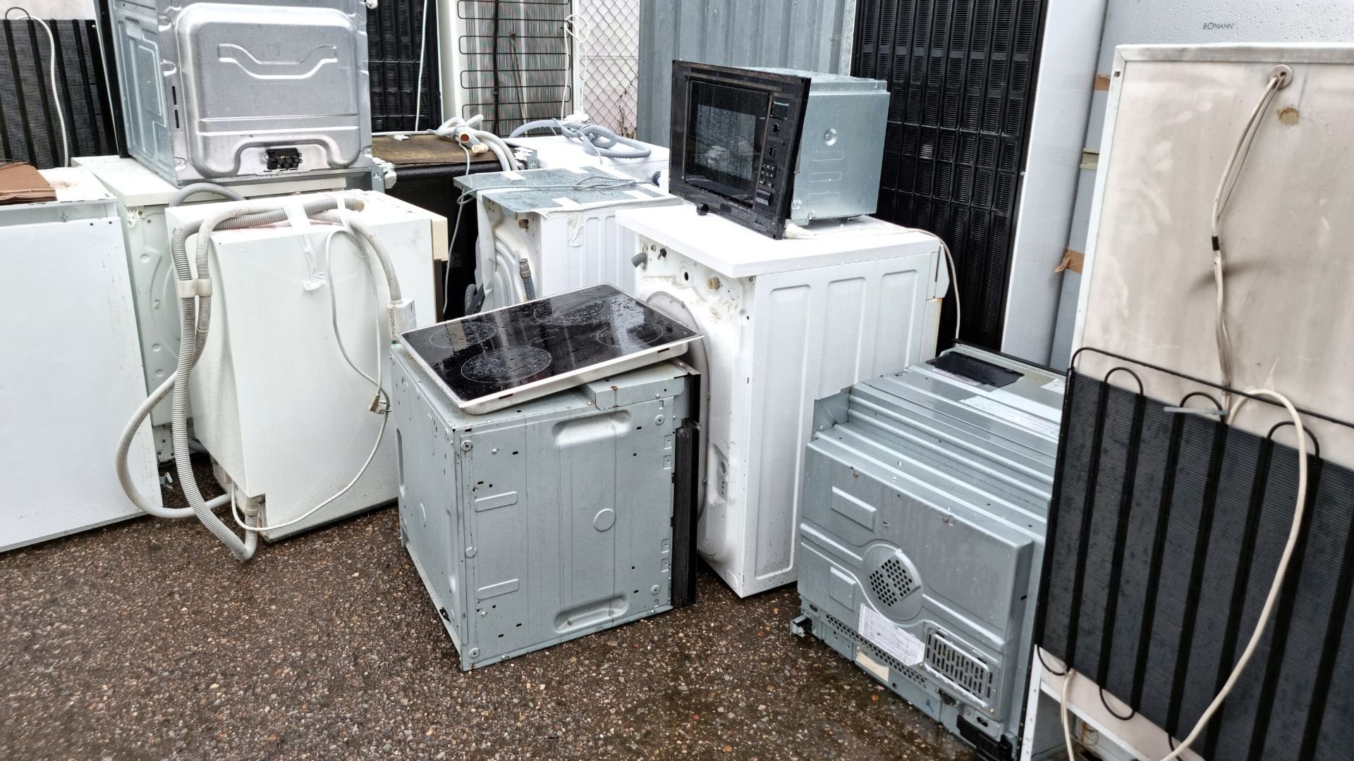 Discarded washing machines and electronic appliances in a scrap yard