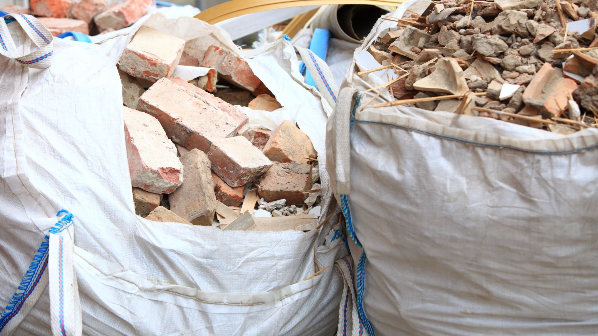 White bags filled with broken bricks and construction debris